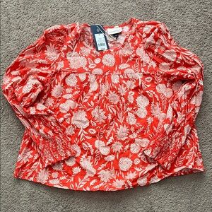 Reddish/orange floral long sleeve blouse with smocked sleeve